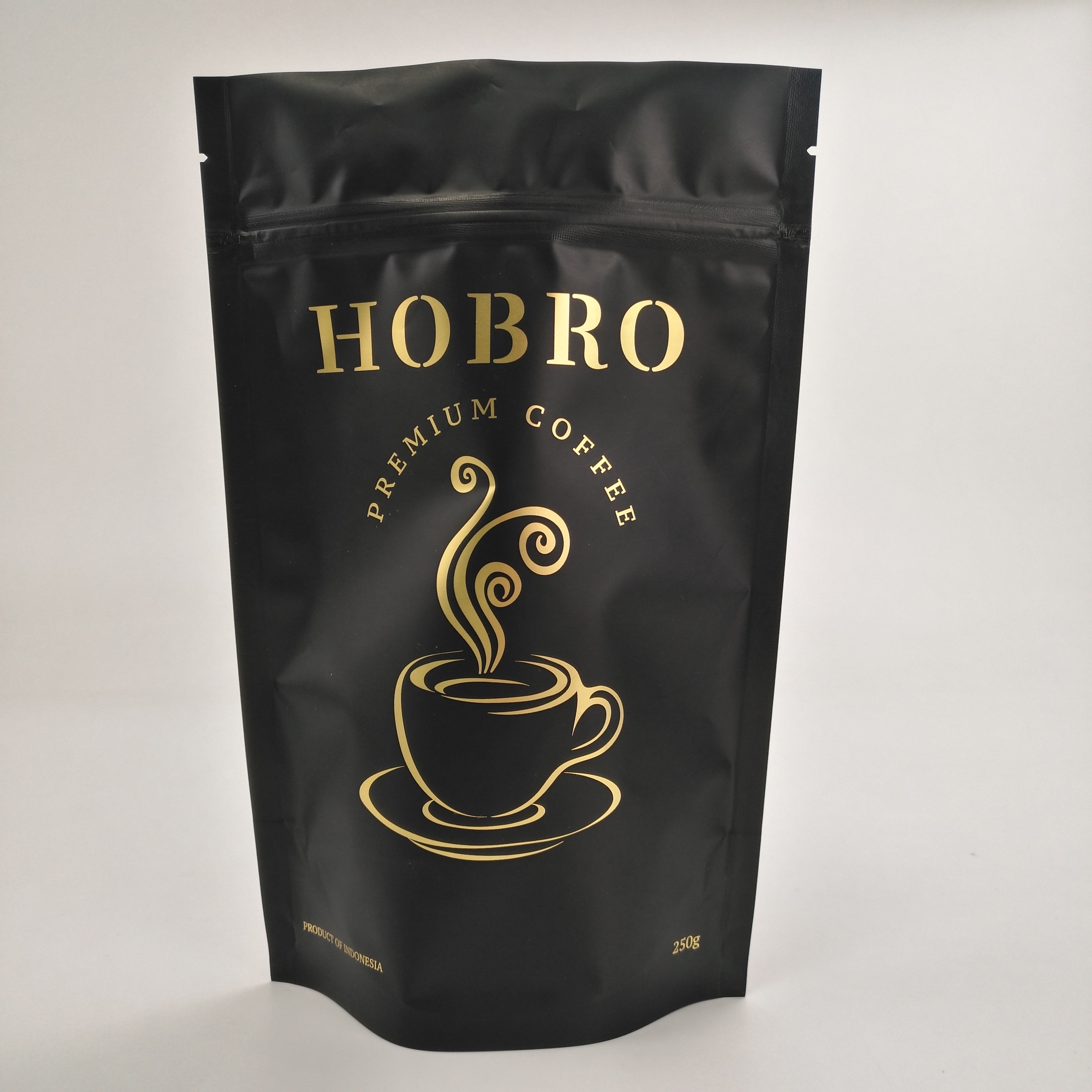 マットの弁が付いている黒い薄板にされたアルミ ホイルのジッパー ロックのコーヒー包装袋のコーヒー豆包装袋の上の立場